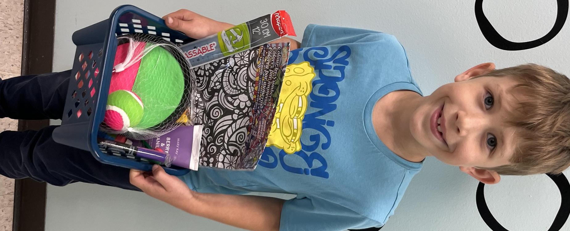 Male student showing his gift basket