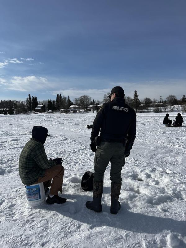 Resource officer with student fishing