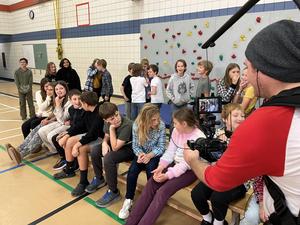 Students acting like they are thinking hard for the camera during the game show.