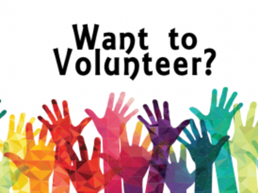 Want to volunteer with colourful hands reaching up towards the words