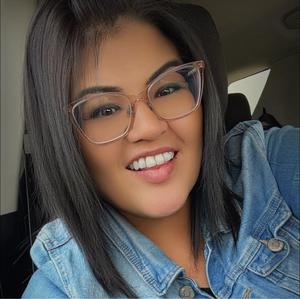 Image of a smiling woman wearing glasses.